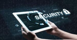 Hands holding a tablet displaying a security concept, emphasizing digital safety and protection.